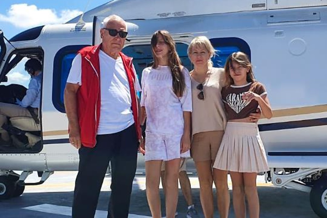 Helicopter cockpit over coastline and city