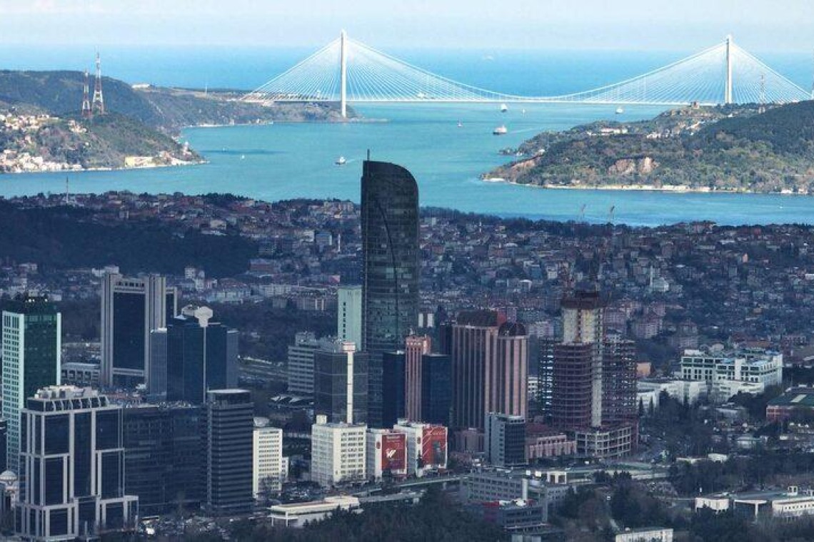 Helicopter cockpit over coastline and city
